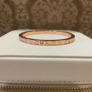 Rose gold coach bangle.